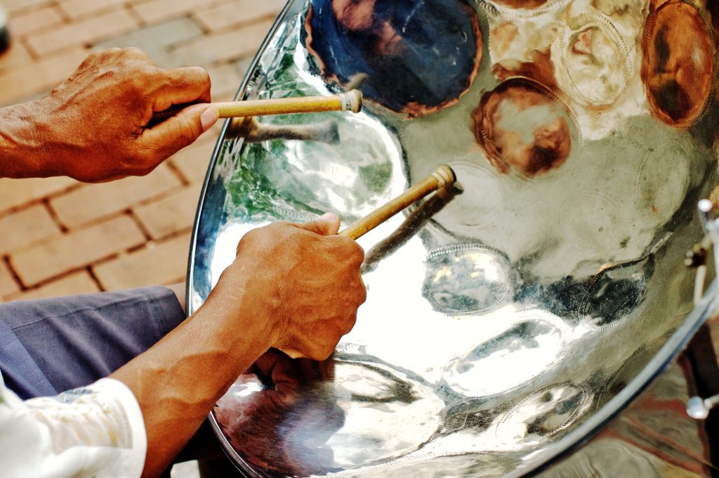 | TriniGo Cheerful sounding Jamaican steel drum player on the city sidewalk